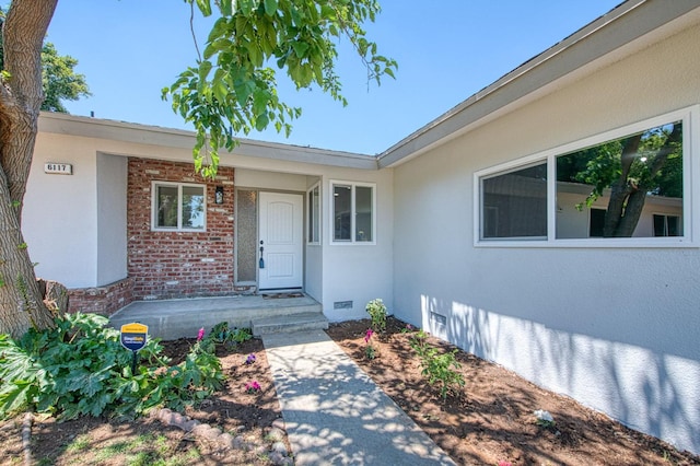 6117 N Colonial Ave, Fresno, CA 93704 - view of exterior entry with brick siding, crawl space, and stucco siding