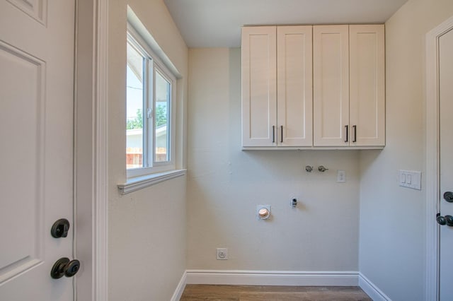 6117 N Colonial Ave, Fresno, CA 93704 - washroom with cabinet space, wood finished floors, baseboards, and hookup for an electric dryer