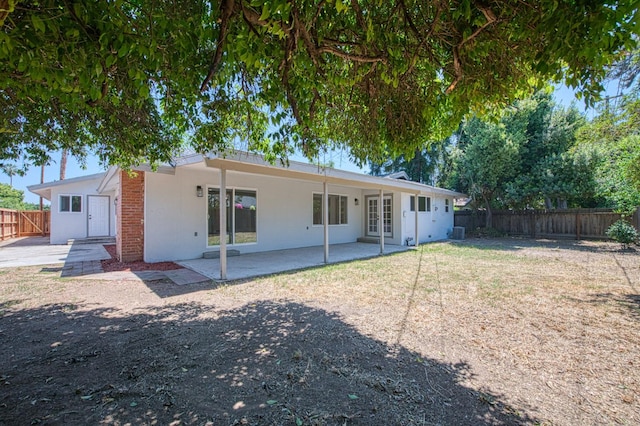 6117 N Colonial Ave, Fresno, CA 93704 - back of house featuring a patio area, a fenced backyard, french doors, stucco siding, and central AC