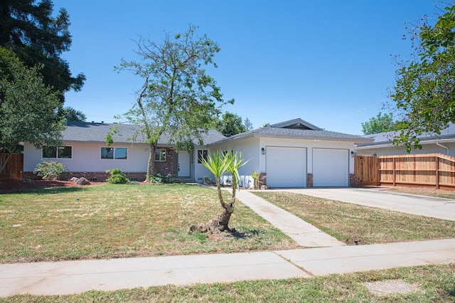 6117 N Colonial Ave, Fresno, CA 93704 - ranch-style house with an attached garage, driveway, brick siding, and stucco siding