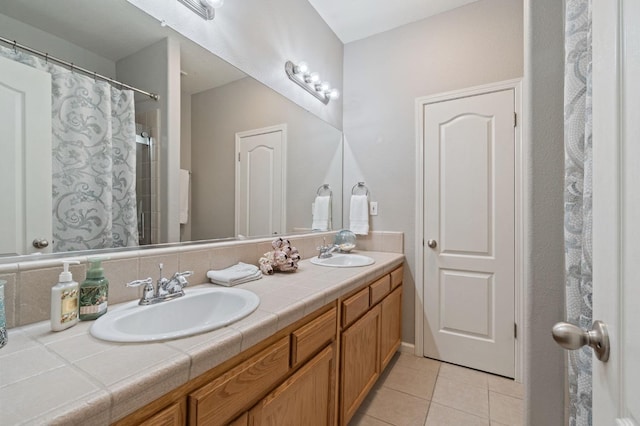 6423 N Bain Ave, Fresno, CA 93722 - bathroom featuring tile patterned flooring and double vanity