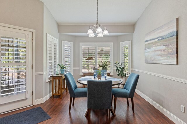 6423 N Bain Ave, Fresno, CA 93722 - dining room with a chandelier, dark wood finished floors, healthy amount of natural light, and baseboards