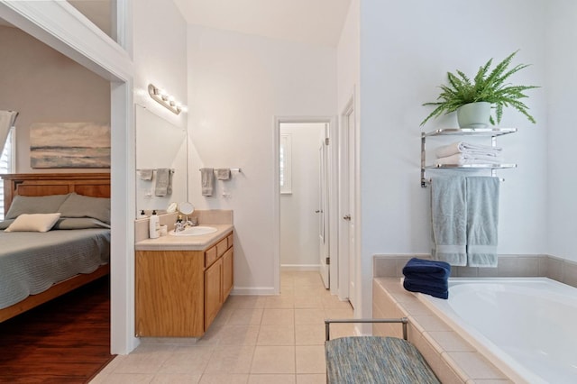 6423 N Bain Ave, Fresno, CA 93722 - full bathroom with vanity, a bath, tile patterned floors, ensuite bath, and baseboards