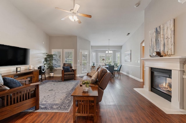 6423 N Bain Ave, Fresno, CA 93722 - living room featuring wood finished floors, a glass covered fireplace, ceiling fan, and baseboards