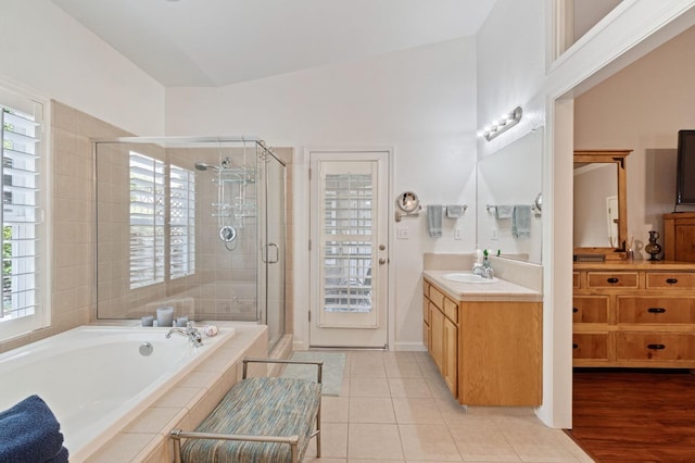6423 N Bain Ave, Fresno, CA 93722 - bathroom featuring a shower stall, vanity, a garden tub, and plenty of natural light