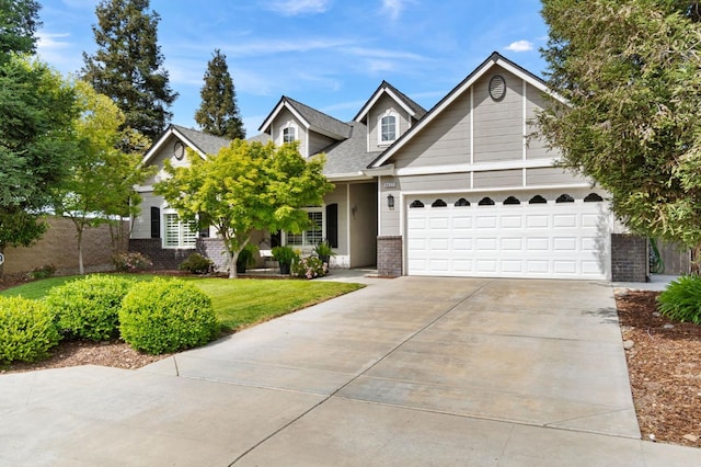 6423 N Bain Ave, Fresno, CA 93722 - view of front of home featuring driveway, brick siding, a front lawn, and an attached garage