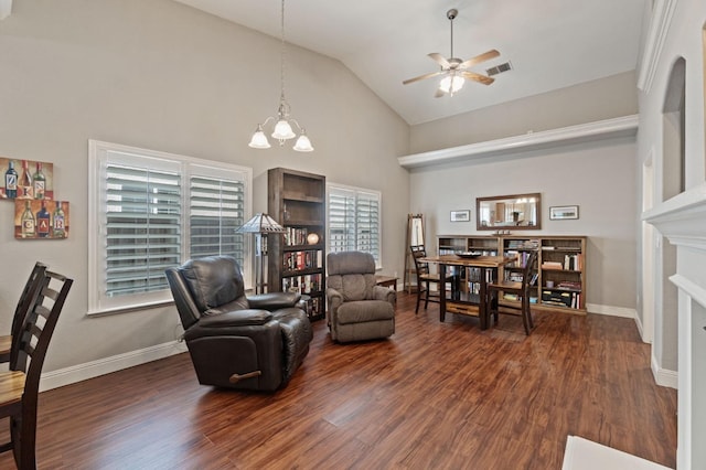 6423 N Bain Ave, Fresno, CA 93722 - living room featuring ceiling fan, dark wood-style flooring, high vaulted ceiling, a chandelier, and baseboards