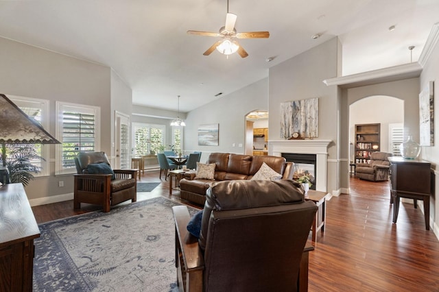 6423 N Bain Ave, Fresno, CA 93722 - living area featuring a ceiling fan, arched walkways, wood finished floors, a multi sided fireplace, and baseboards