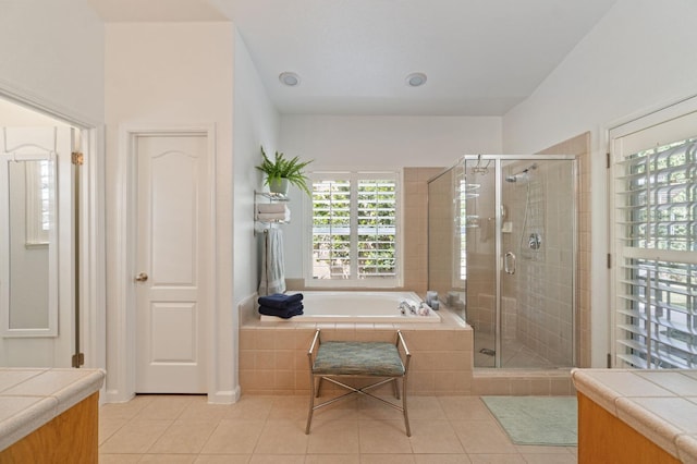 6423 N Bain Ave, Fresno, CA 93722 - full bathroom with tile patterned flooring, a shower stall, a garden tub, and vanity