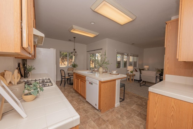 3137 Indianapolis Ave, Clovis, CA 93619 - kitchen with white appliances, tile counters, a kitchen breakfast bar, open floor plan, and a center island