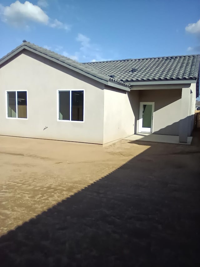 820 Shasta St, Madera, CA 93638 - back of property featuring a tile roof, stucco siding, and a patio area