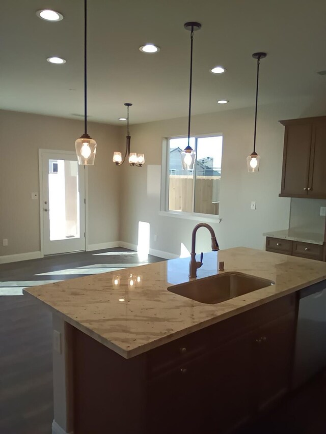 820 Shasta St, Madera, CA 93638 - kitchen with a sink, recessed lighting, baseboards, pendant lighting, and light stone countertops