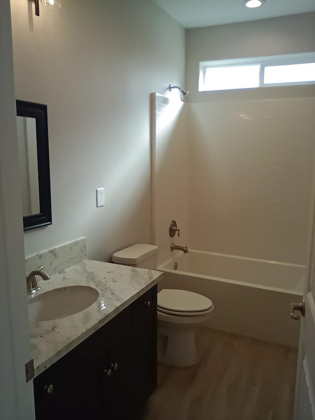 820 Shasta St, Madera, CA 93638 - bathroom with toilet, wood finished floors, vanity, and shower / bathtub combination
