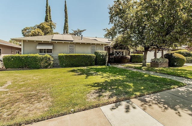 5082 N Maroa Ave, Fresno, CA 93704 - view of front of house with a front lawn, solar panels, stucco siding, and roof with shingles