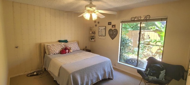 6300 N Palm Ave Unit 108, Fresno, CA 93710 - bedroom with carpet, a textured ceiling, a ceiling fan, and wooden walls