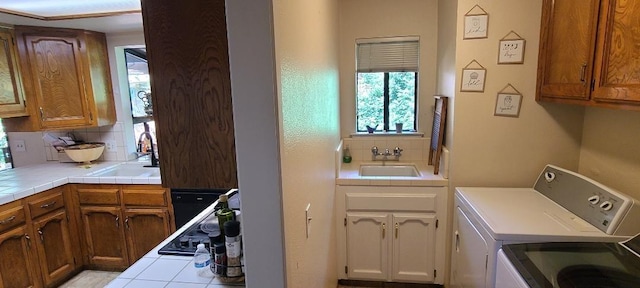6300 N Palm Ave Unit 108, Fresno, CA 93710 - laundry room featuring washer and clothes dryer, plenty of natural light, and cabinet space