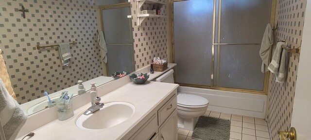 6300 N Palm Ave Unit 108, Fresno, CA 93710 - bathroom with tile patterned flooring, toilet, vanity, and shower / bath combination with glass door