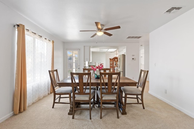 977 E Pennsylvania Ave, Fresno, CA 93720 - dining room with light carpet, a ceiling fan, and baseboards