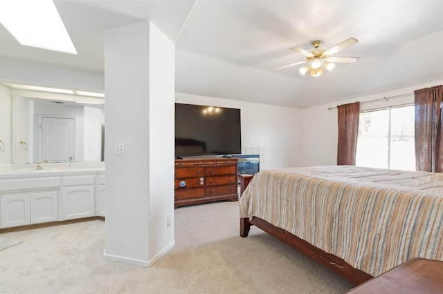 977 E Pennsylvania Ave, Fresno, CA 93720 - bedroom featuring light colored carpet, a sink, connected bathroom, a skylight, and baseboards