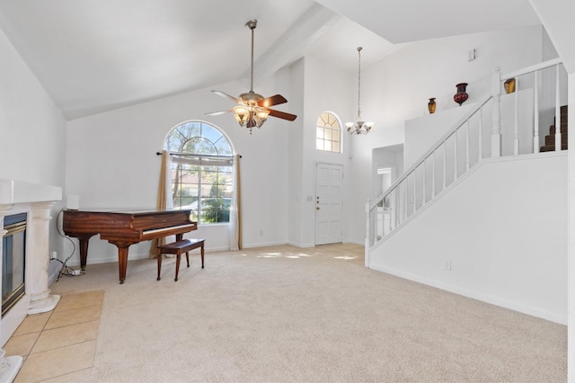 977 E Pennsylvania Ave, Fresno, CA 93720 - carpeted entrance foyer featuring stairs, high vaulted ceiling, ceiling fan, a glass covered fireplace, and baseboards