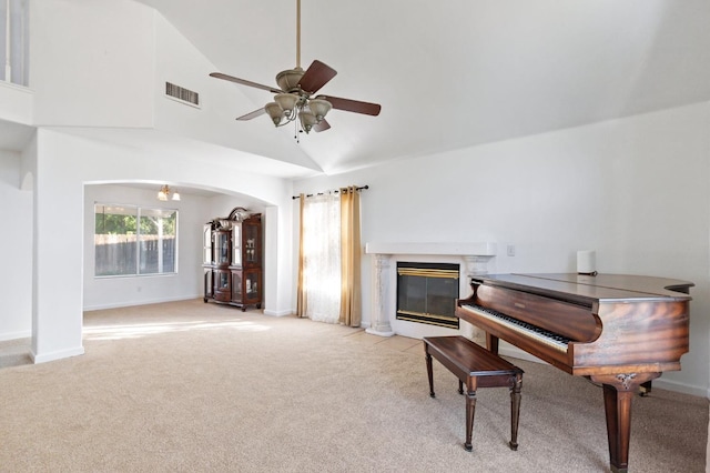 977 E Pennsylvania Ave, Fresno, CA 93720 - sitting room with light colored carpet, ceiling fan, plenty of natural light, arched walkways, and high vaulted ceiling