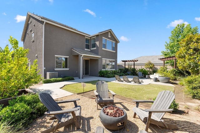 11289 N Alicante Dr, Fresno, CA 93730 - rear view of property with an outdoor fire pit, a patio, stucco siding, a yard, and central air condition unit