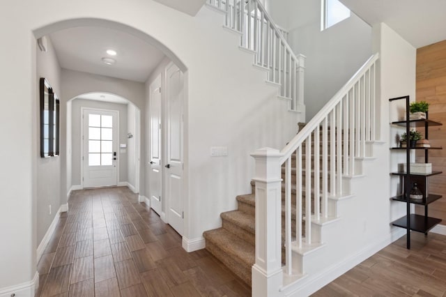 11289 N Alicante Dr, Fresno, CA 93730 - entrance foyer featuring arched walkways, wood finished floors, stairway, and baseboards