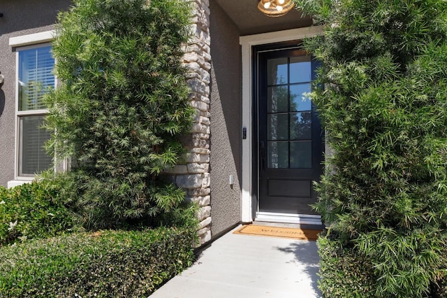 11289 N Alicante Dr, Fresno, CA 93730 - doorway to property with stucco siding