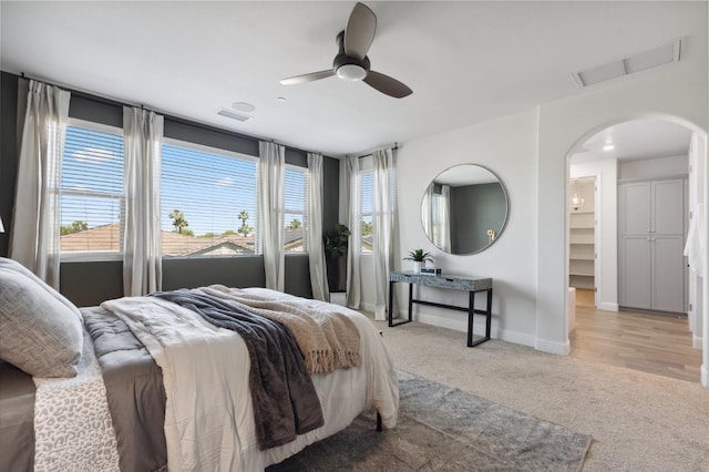 11289 N Alicante Dr, Fresno, CA 93730 - bedroom featuring light carpet, arched walkways, baseboards, and ceiling fan