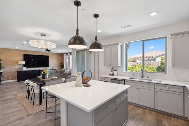 11289 N Alicante Dr, Fresno, CA 93730 - kitchen with a sink, gray cabinets, stainless steel dishwasher, light wood-type flooring, and decorative backsplash