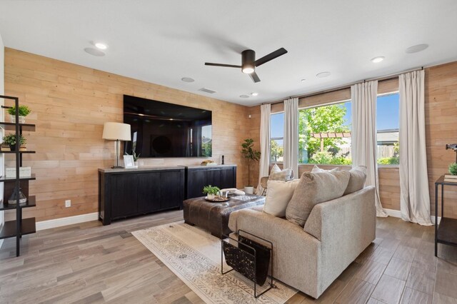11289 N Alicante Dr, Fresno, CA 93730 - living area featuring ceiling fan, light wood-type flooring, wooden walls, baseboards, and recessed lighting