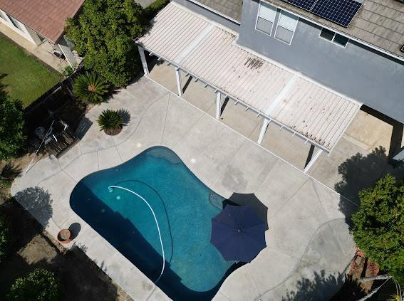 view of subject property with a pool area