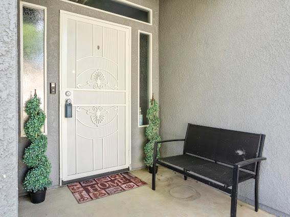 view of exterior entry featuring stucco siding