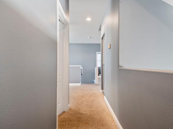 hallway with carpet flooring and recessed lighting