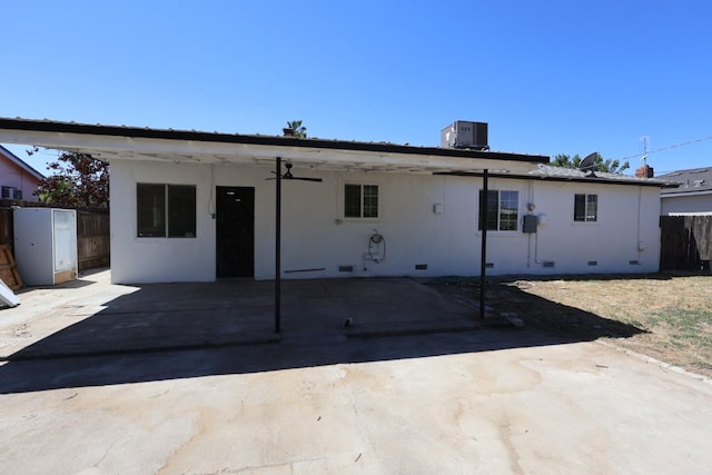 445 Shaw Ave, Clovis, CA 93612 - back of property with fence, crawl space, central air condition unit, a patio, and stucco siding