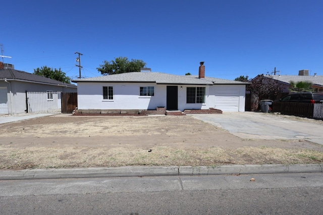 445 Shaw Ave, Clovis, CA 93612 - view of front of home featuring a garage, fence, concrete driveway, a chimney, and stucco siding