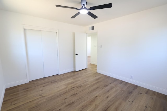 445 Shaw Ave, Clovis, CA 93612 - unfurnished bedroom with wood finished floors, baseboards, a closet, and ceiling fan