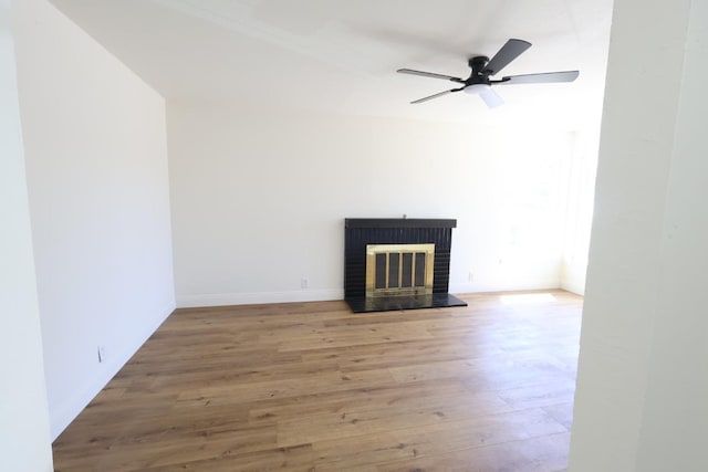 445 Shaw Ave, Clovis, CA 93612 - unfurnished living room featuring a brick fireplace, wood finished floors, ceiling fan, and baseboards