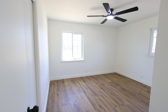 445 Shaw Ave, Clovis, CA 93612 - unfurnished room with wood finished floors, ceiling fan, and baseboards