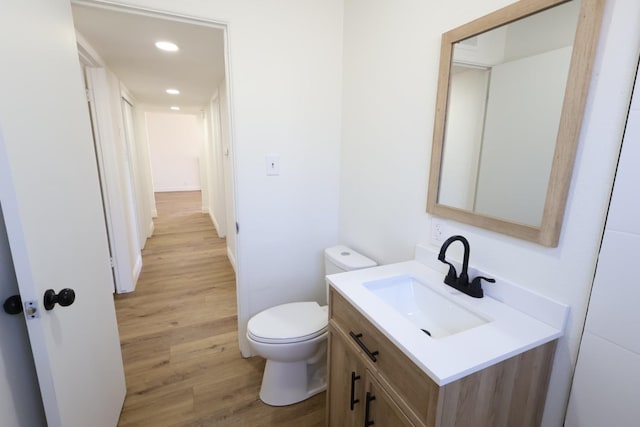 445 Shaw Ave, Clovis, CA 93612 - half bath featuring wood finished floors, vanity, toilet, and recessed lighting