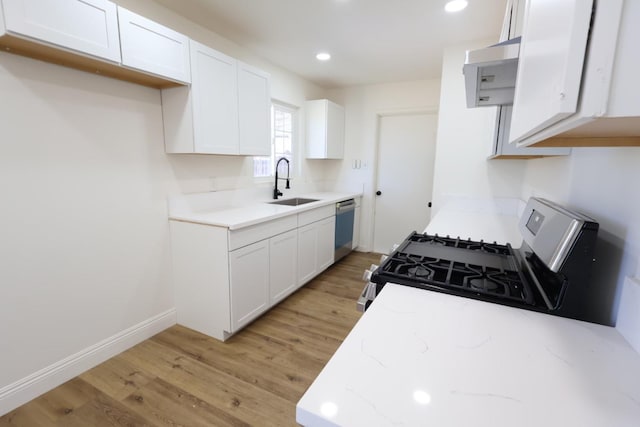 445 Shaw Ave, Clovis, CA 93612 - kitchen featuring stainless steel gas stove, dishwasher, a sink, light wood-type flooring, and white cabinetry