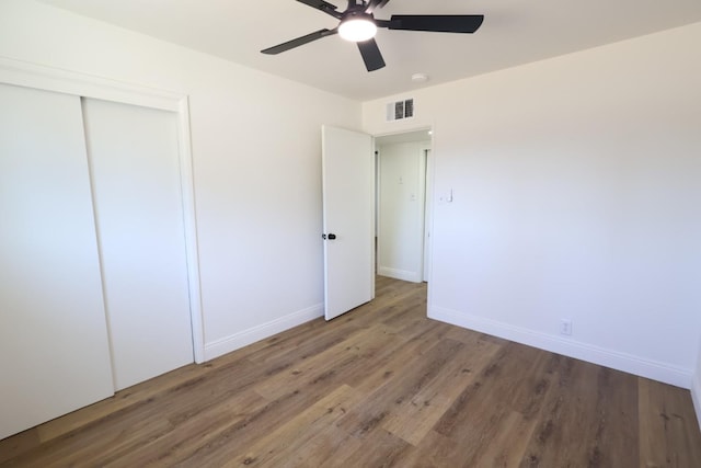 445 Shaw Ave, Clovis, CA 93612 - unfurnished bedroom with wood finished floors, baseboards, a closet, and a ceiling fan
