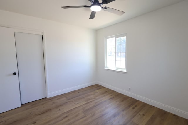 445 Shaw Ave, Clovis, CA 93612 - unfurnished bedroom featuring wood finished floors, baseboards, ceiling fan, and a closet