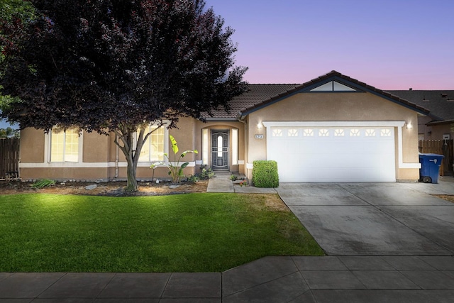 ranch-style house featuring stucco siding, a garage, driveway, and a tile roof