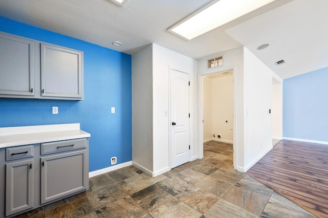 6254 E Bellaire Way, Fresno, CA 93727 - kitchen featuring gray cabinets, light countertops, and dark stone finish floors
