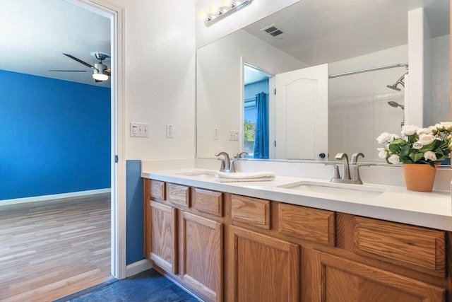 6254 E Bellaire Way, Fresno, CA 93727 - bathroom featuring double vanity, wood finished floors, and a ceiling fan