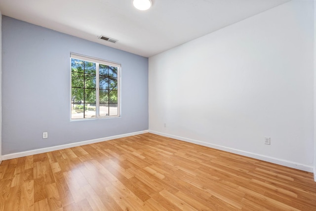 unfurnished room featuring light wood-style flooring and baseboards
