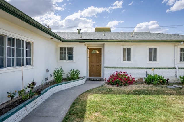 5535 N Millbrook Ave, Fresno, CA 93710 - property entrance featuring a lawn, stucco siding, brick siding, and roof with shingles