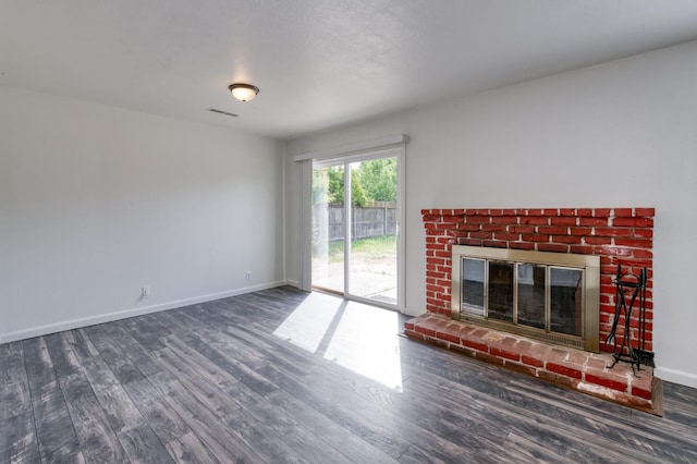 5535 N Millbrook Ave, Fresno, CA 93710 - unfurnished living room with wood finished floors, a brick fireplace, and baseboards