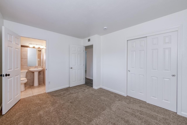 5535 N Millbrook Ave, Fresno, CA 93710 - unfurnished bedroom featuring carpet, a closet, a sink, baseboards, and ensuite bathroom